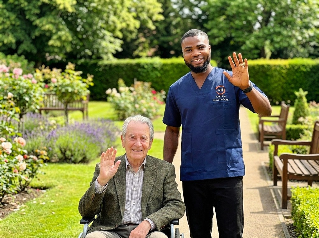 Karisla Healthcare support worker and client waving together in garden setting